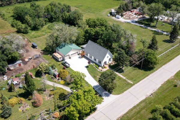 aerial view of home showing property with yard and trees